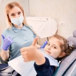 a girl is getting dental treatment